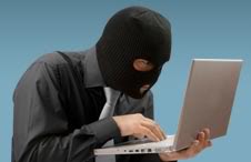 Guy in Ski Mask holding Laptop